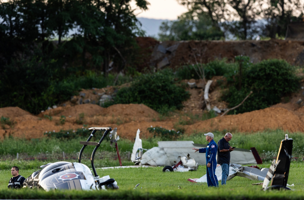 Authorities investigate a crash between a Pennsylvania State Police helicopter and a small plane at the Carlisle airport in Carlisle, Pa. Wednesday, Aug. 19, 2026. (Sean Simmers/The Patriot-News via AP)