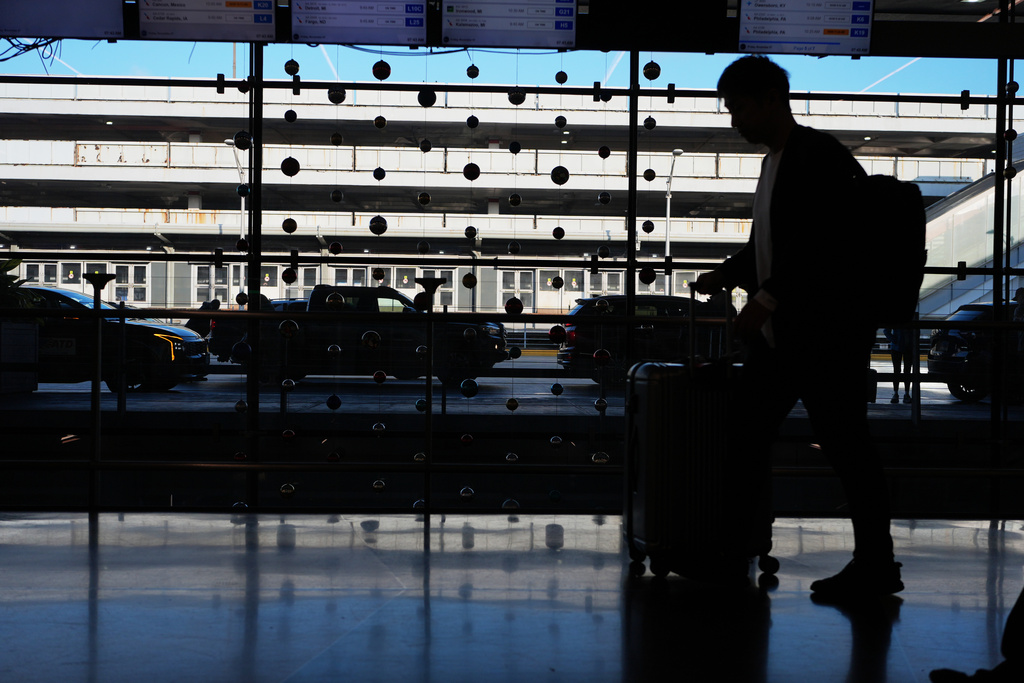A traveler arrives at O'Hare International Airport in Chicago, Friday, Nov. 7, 2025. (AP Photo/Nam Y. Huh)