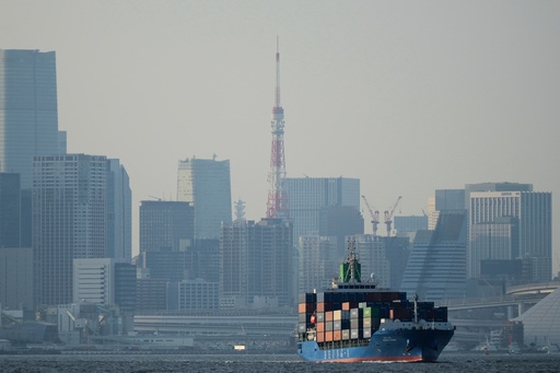 FILE - Tokyo Tower is visible amid tall buildings as a container ship leaves a cargo terminal in Tokyo, April 9, 2025. (AP Photo/Hiro Komae, File) FILE - Tokyo Tower is visible amid tall buildings as a container ship leaves a cargo terminal in Tokyo, April 9, 2025. (AP Photo/Hiro Komae, File)