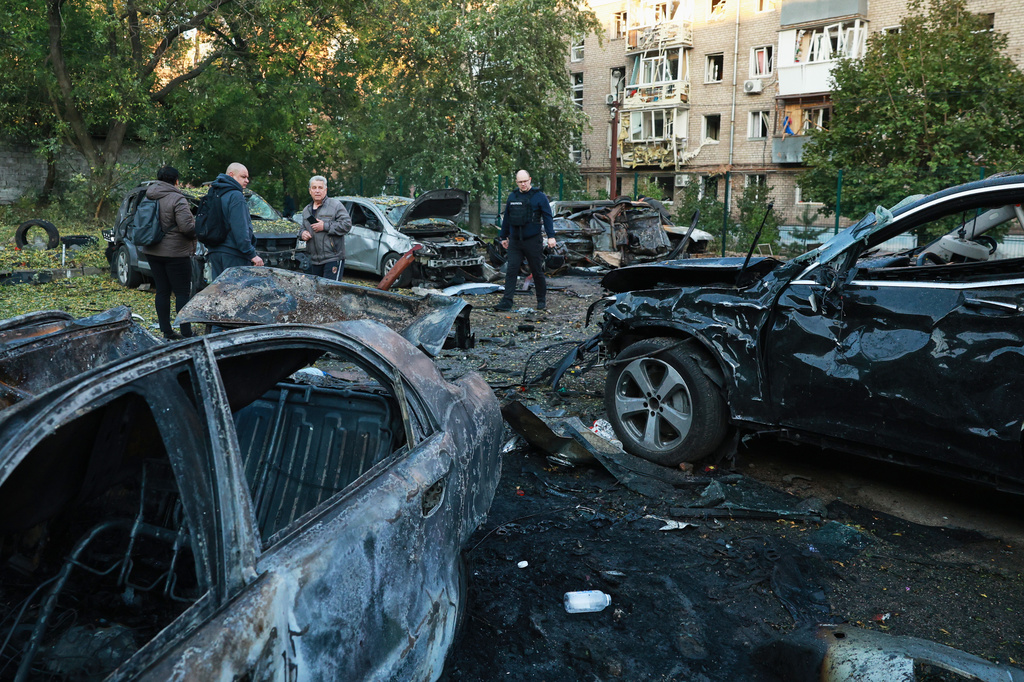 Cars are seen damaged by a Russian strike on residential neighbourhood in Zaporizhzhia, Ukraine, Friday, Oct. 9, 2026. (AP Photo/Kateryna Klochko)