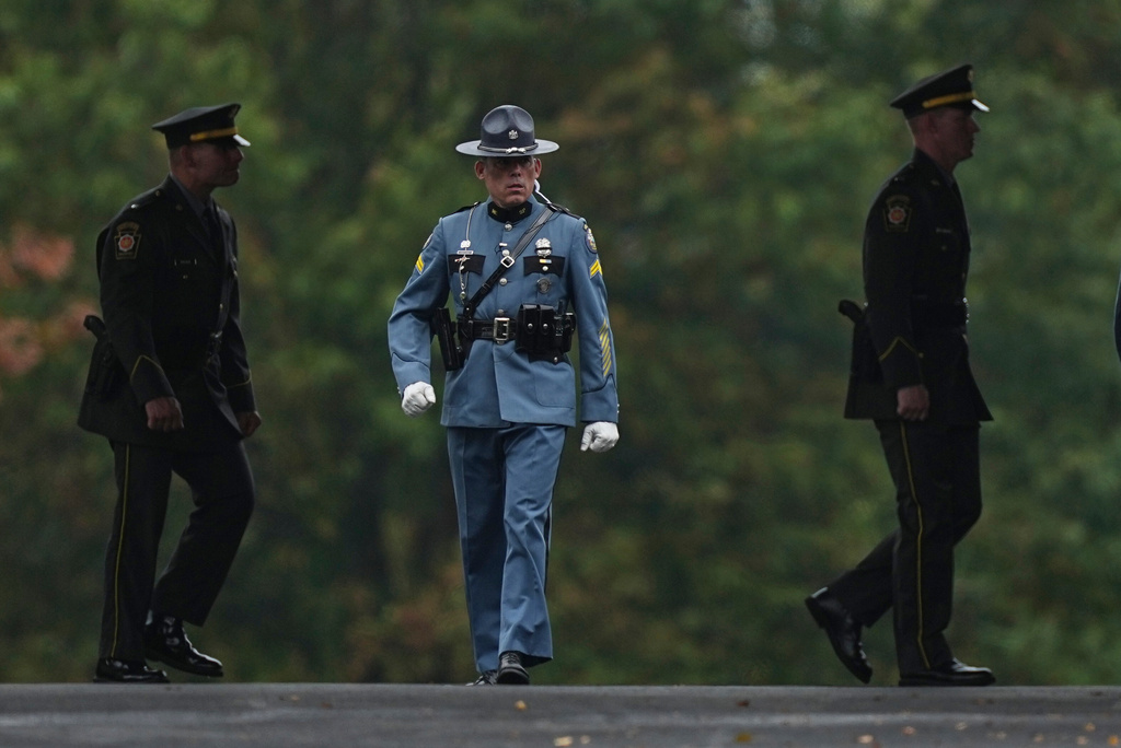 Officers attend funeral services for slain Northern York County Regional Police detectives Cody Michael Becker, Mark Edward Baker and Isaiah Emenheiser, Thursday, Sept. 25, 2025, in Red Lion, Pa. (AP Photo/Matt Rourke)