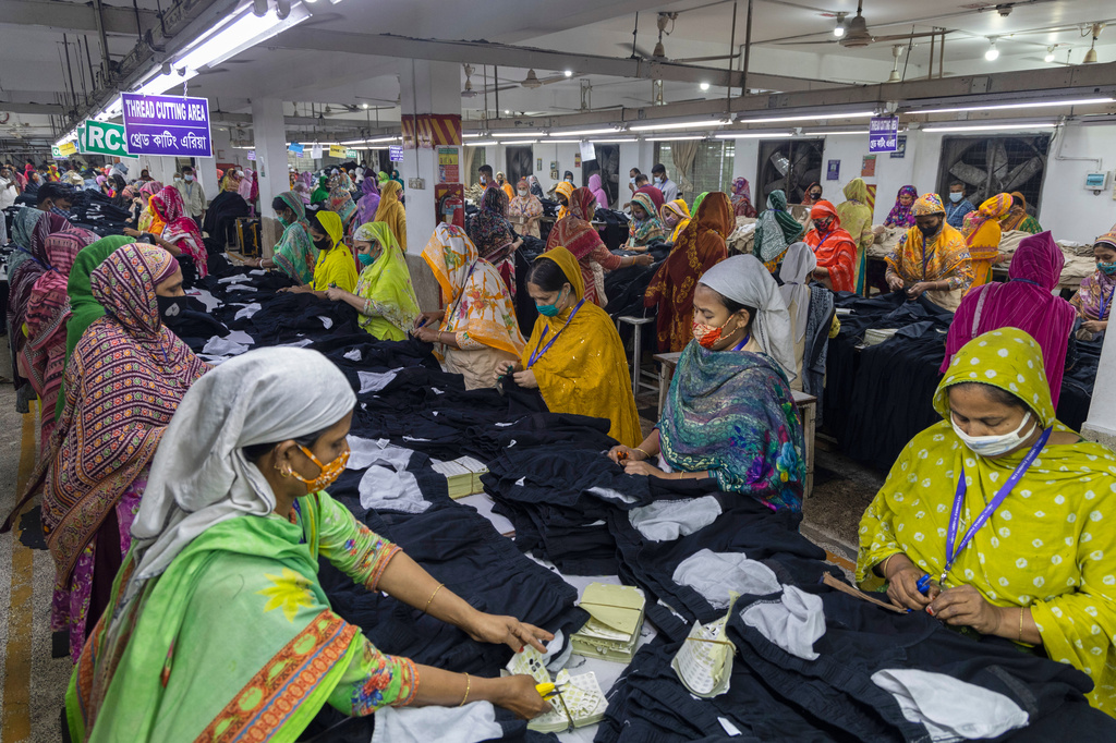 Women workers assemble apparel at a garment factory in Dhaka, Bangladesh, Tuesday, April 28, 2026. (AP Photo/Abdul Goni)