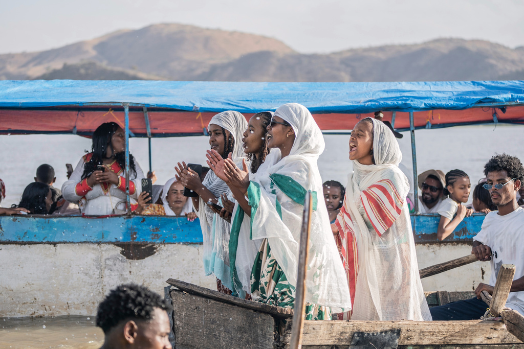 Ethiopian orthodox believers ride a boat to celebrate Timket, the Ethiopian Epiphany, on lake Dembel, in Batu, Ethiopia, Sunday, Jan. 18, 2026. (AP Photo/Amanuel Sileshi)