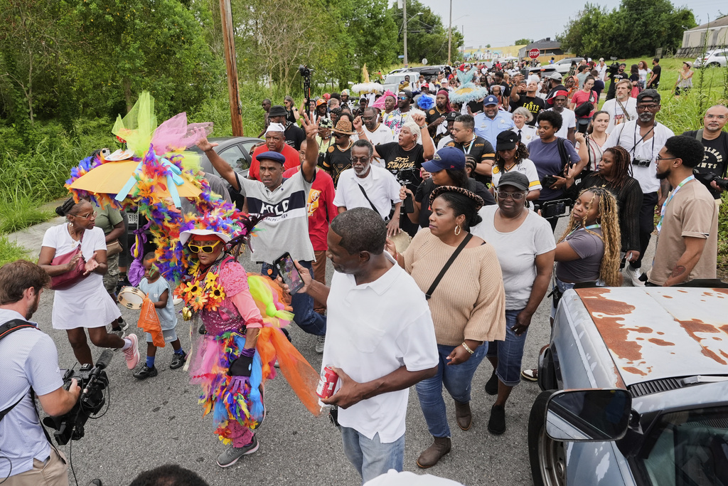 People form a second line parade during an event to commemorate the 20th anniversary of Hurricane Katrina, in the Lower Ninth Ward of New Orleans, Friday, Aug. 29, 2025. (AP Photo/Alex Brandon)