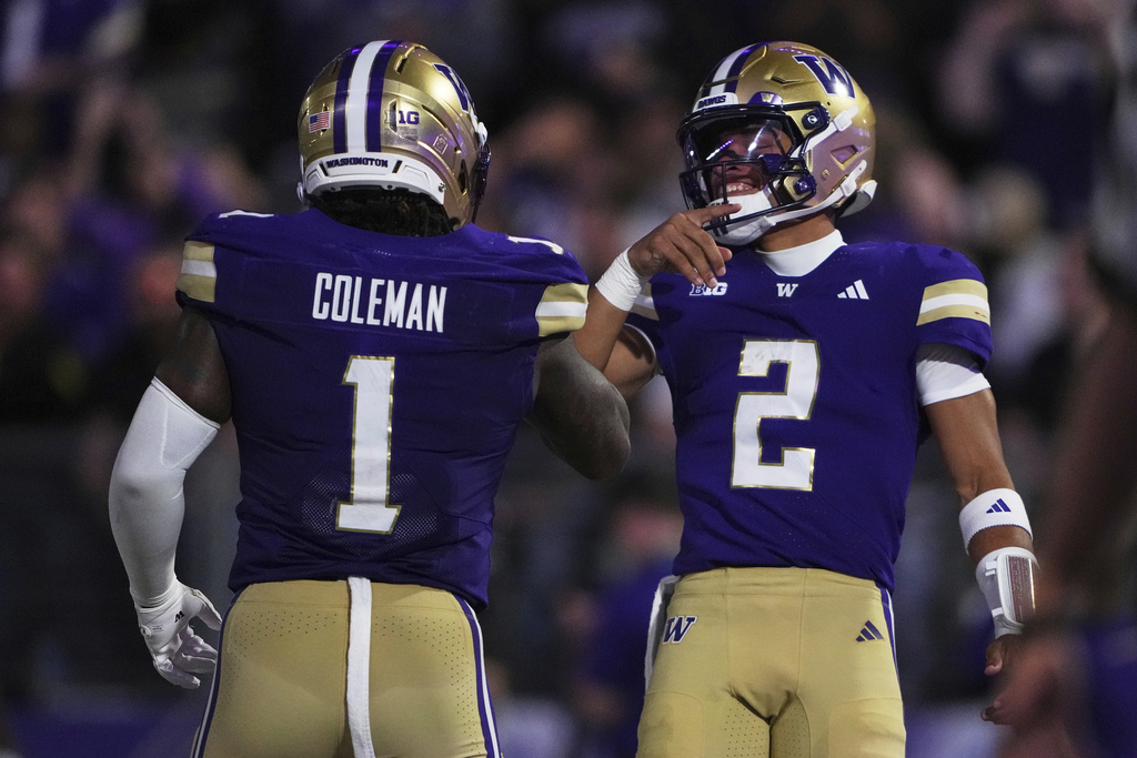 Washington running back Jonah Coleman (1) celebrates his touchdown with quarterback Demond Williams Jr. (2) against UC Davis during the first half of an NCAA college football game, Saturday, Sept. 6, 2025, in Seattle. (AP Photo/Lindsey Wasson)