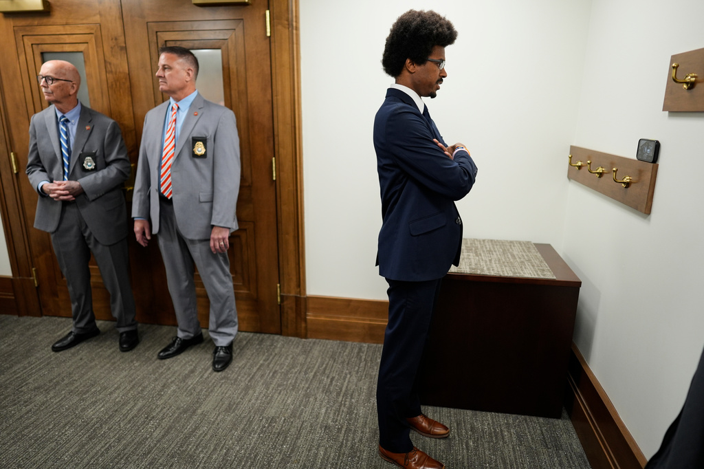 Rep. Justin J. Pearson, D-Memphis, watches a Senate Judiciary committee meeting on his phone outside the hearing room during a special session of the state legislature to redraw U.S. Congressional voting maps Wednesday, May 6, 2026, in Nashville, Tenn. (AP Photo/George Walker IV)