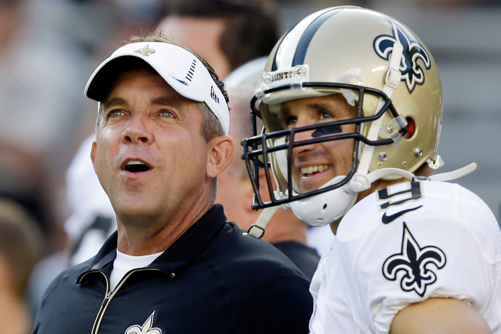 FILE - New Orleans Saints head coach Sean Payton talks to quarterback Drew Brees before a preseason NFL football game against the Green Bay Packers, Sept. 3, 2015, in Green Bay, Wis. (AP Photo/Jeffrey Phelps, File)