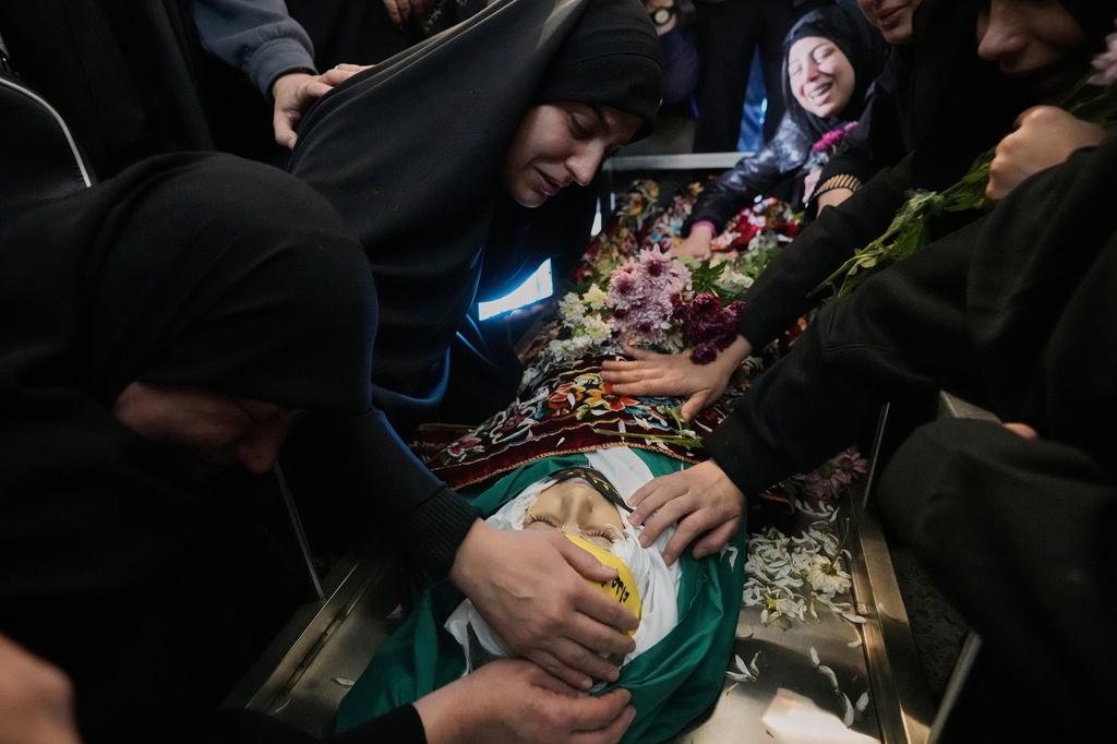 The mother of Jawad Younes,11, who was killed on Friday in an Israeli airstrike, mourns over his body during a funeral procession in Saksakiyeh village, south Lebanon, Saturday, March 28, 2026. (AP Photo/Hussein Malla)