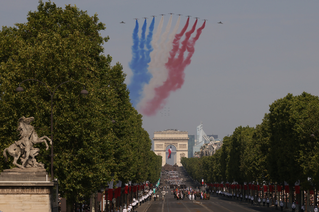 Jets from the acrobatic Patrouille de France fly during the Bastille Day military parade on the Champs-Elysees avenue in Paris, Tuesday, July 14, 2026. (AP Photo/Thomas Padilla)