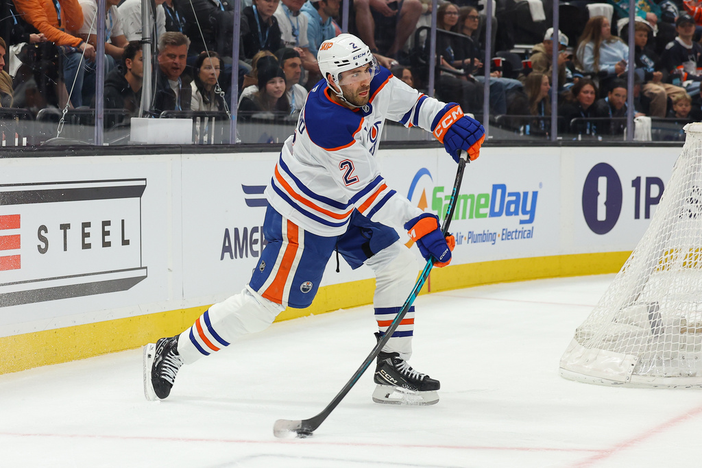 Edmonton Oilers defenseman Evan Bouchard (2) passes the puck against the Utah Mammoth during the second period of an NHL hockey game, Tuesday, March 24, 2026, in Salt Lake City. (AP Photo/Melissa Majchrzak)