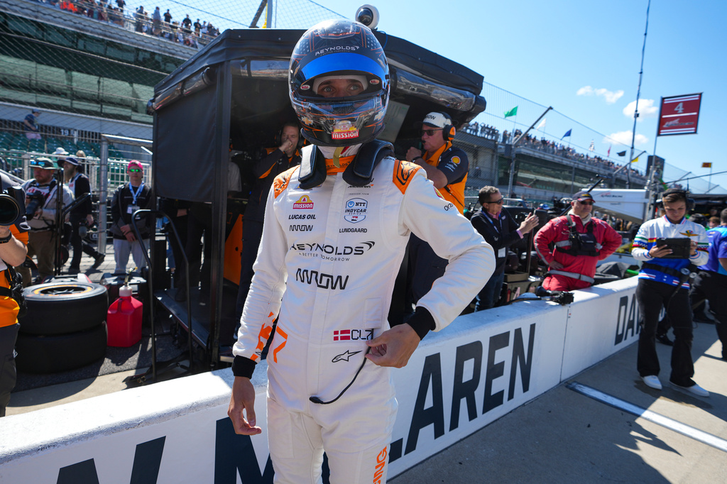 FILE - Christian Lundgaard, of Denmark, waits to climb into his car before the start practice for the Indianapolis 500 auto race at Indianapolis Motor Speedway in Indianapolis, May 23, 2025. (AP Photo/Michael Conroy, File)