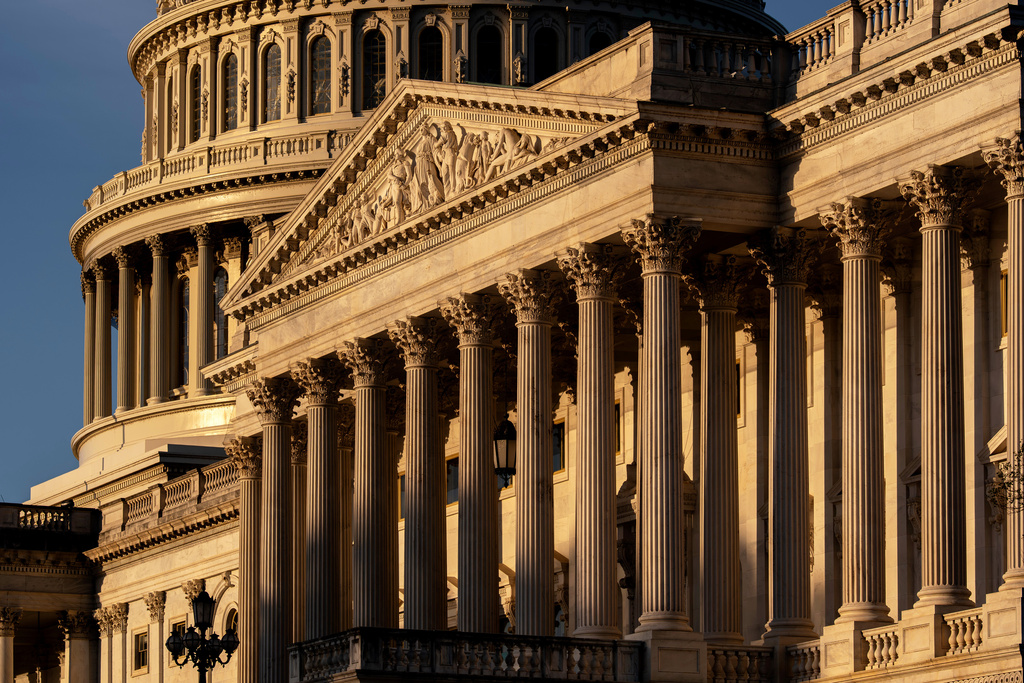 The Capitol is illuminated at sunrise to begin day three of a government shutdown, in Washington, Friday, Oct. 3, 2025. (AP Photo/J. Scott Applewhite)