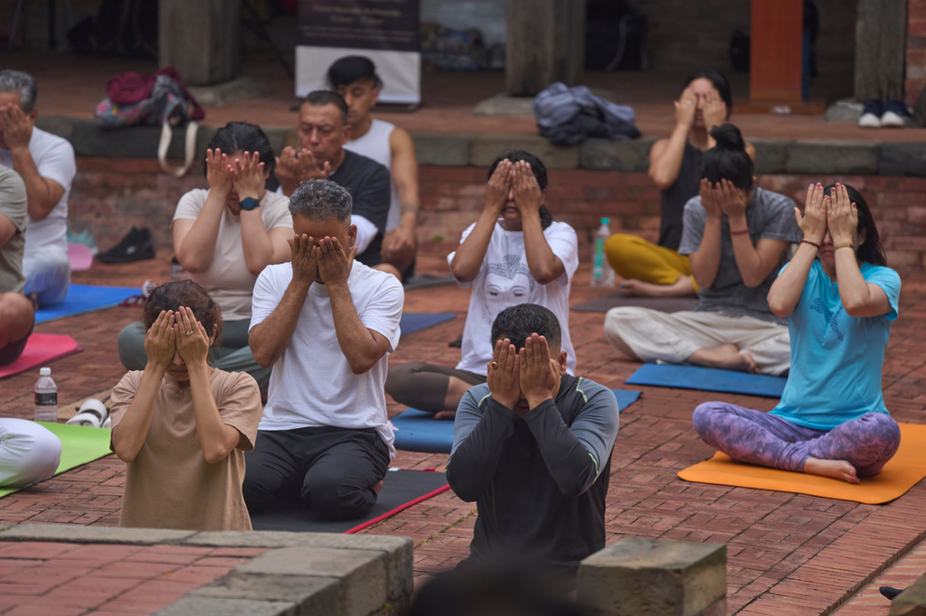 People perform yoga on International Yoga Day in Lalitpur, Nepal, Sunday, June 21, 2026. (AP Photo/Niranjan Shrestha)