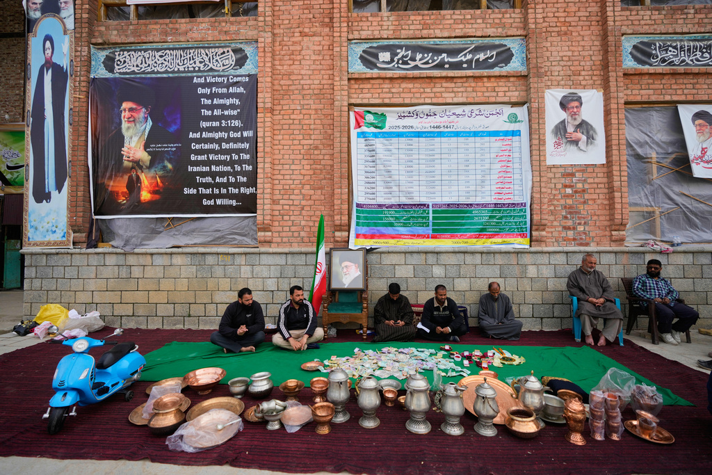 Volunteers wait at a collection point during a donation drive for Iran in Budgam, Indian-controlled Kashmir, Monday, March 23, 2026. (AP Photo/Mukhtar Khan)