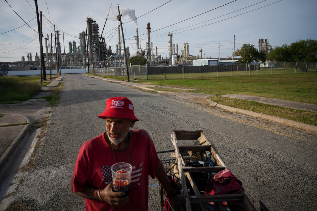 Gavino Rivera talks about the decline of the Hillcrest neighborhood Thursday, Nov. 16, 2023, as he gathers scrap metal near a Citgo oil refinery in Corpus Christi, Texas. (Jon Shapley/Houston Chronicle via AP)