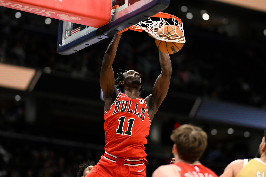Chicago Bulls forward Leonard Miller (11) dunks during the first half of an NBA basketball game against the Washington Wizards, Thursday, April 9, 2026, in Washington. (AP Photo/Nick Wass)