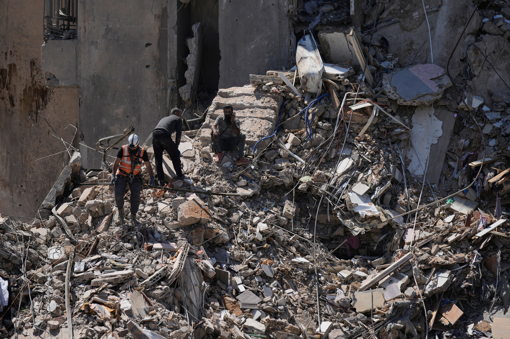 Rescue workers search through the rubble of a building destroyed in an Israeli airstrike the previous day in Dahiyeh, Beirut's southern suburbs, Lebanon, Thursday, May 7, 2026. (AP Photo/Bilal Hussein)