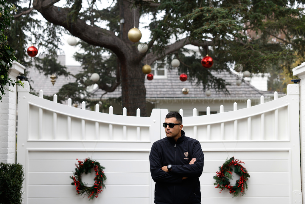 A security guard stands outside Rob Reiner's residence Monday, Dec. 15, 2025, in the Brentwood section of Los Angeles. (AP Photo/Caroline Brehman)