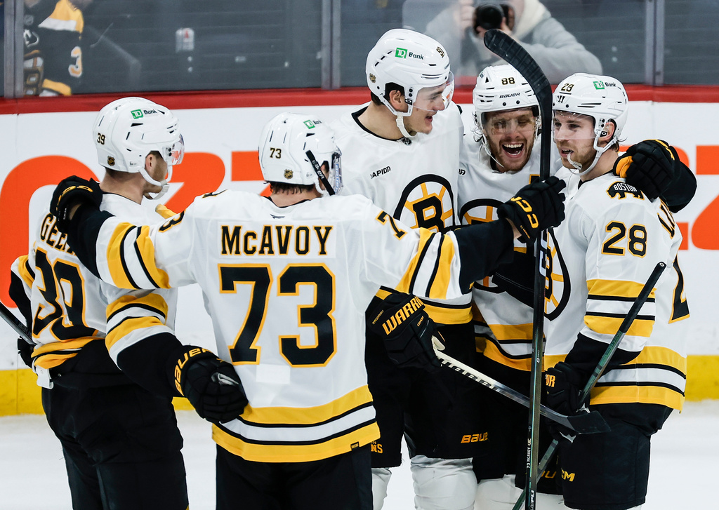 Boston Bruins players celebrate Elias Lindholm's (28) goal against the Winnipeg Jets during the third period of of an NHL hockey game, in Winnipeg, Manitoba, Thursday, Dec. 11, 2025. (John Woods/The Canadian Press via AP)