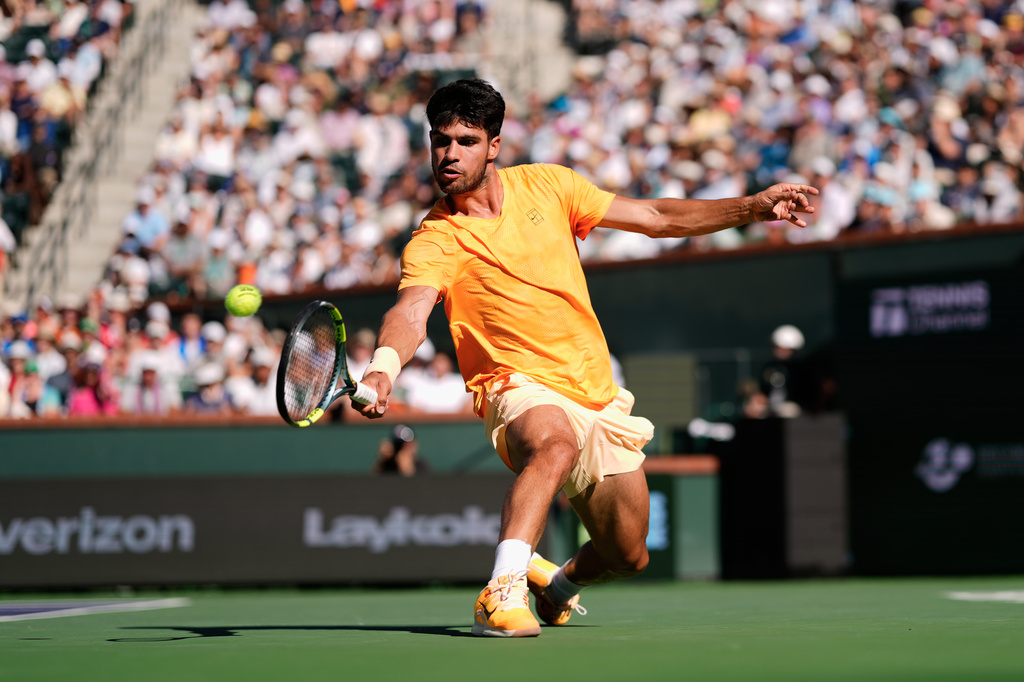 FILE - Carlos Alcaraz, of Spain, returns a shot against Daniil Medvedev, of Russia, during a semifinal match at the BNP Paribas Open tennis tournament, March 14, 2026, in Indian Wells, Calif. (AP Photo/Mark J. Terrill, File)
