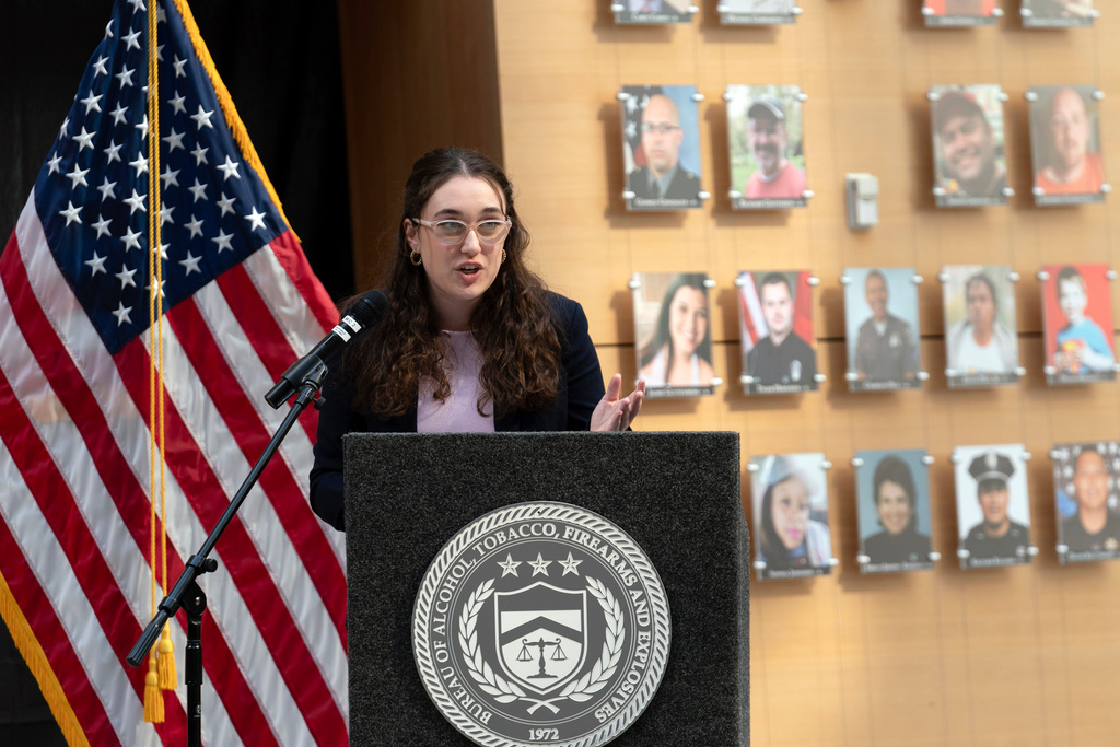 FILE - Survivor of gun violence Mia Tretta speaks while standing next to a wall with photographs of victims of gun violence during the Inaugural Gun Violence Survivors' Summit at ATF Headquarters in Washington, April 23, 2024. (AP Photo/Jose Luis Magana, File)
