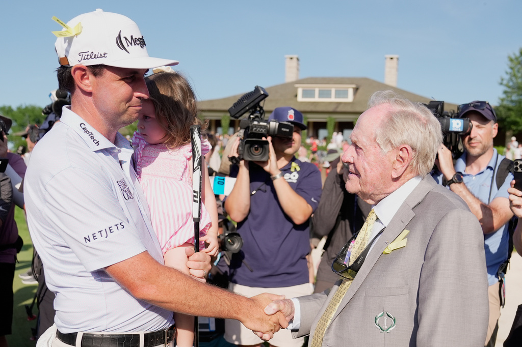 J.T. Poston shakes hands with Jack Nicklaus after winning the Memorial golf tournament, Sunday, June 7, 2026, in Dublin, Ohio. (AP Photo/Sue Ogrocki)