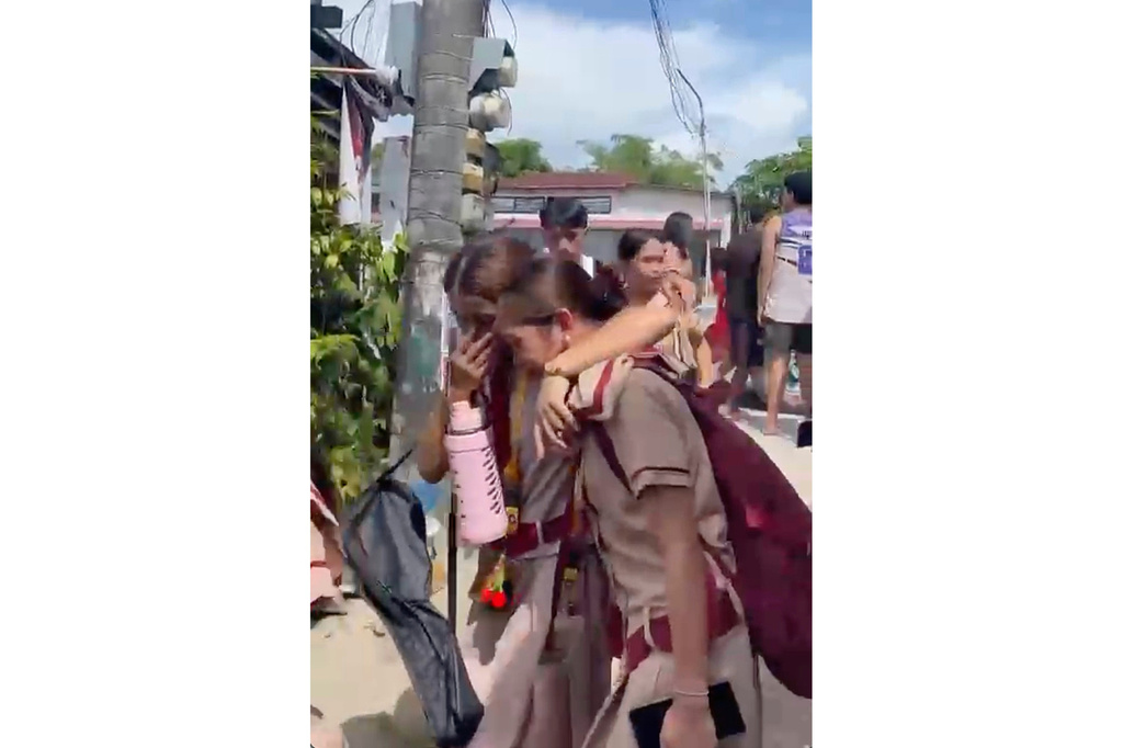 In this photo taken from a video, students react after a shooting incident at the San Jose National High School in Tacloban city, Philippines Monday, June 22, 2026. (James Daantos via AP Photo)