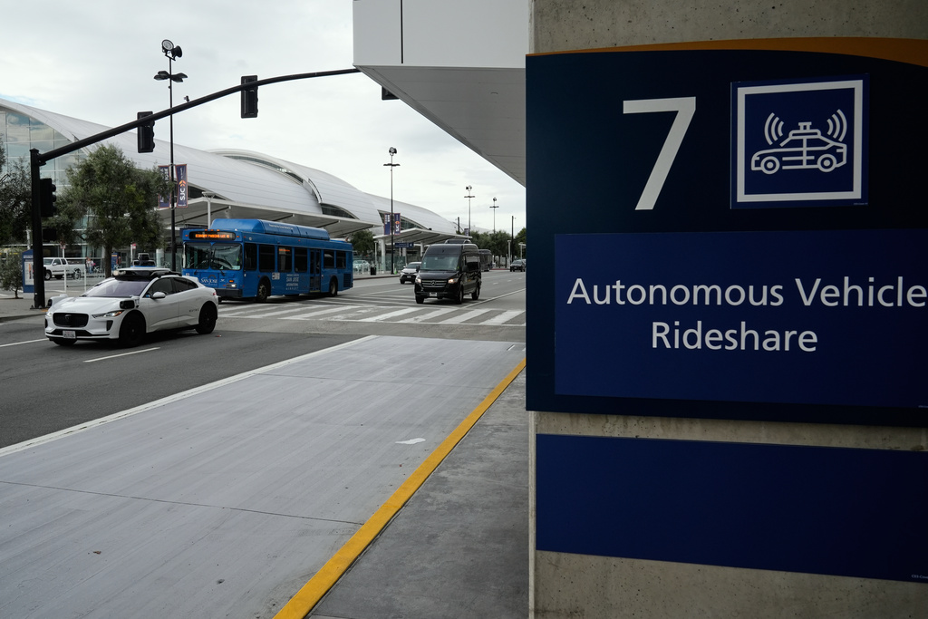 A Waymo vehicle travels past Terminal B at the San Jose Mineta International Airport, Wednesday, Nov. 12, 2025, in San Jose, Calif. (AP Photo/Godofredo A. Vásquez)