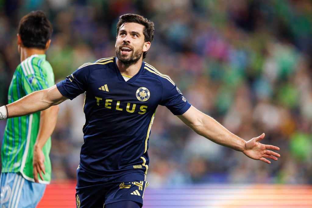Vancouver Whitecaps FC forward Brian White celebrates scoring a goal during the second half of an MLS soccer match against Seattle Sounders FC on Saturday, Sept. 27, 2025, in Seattle. (AP Photo/Kevin Ng)