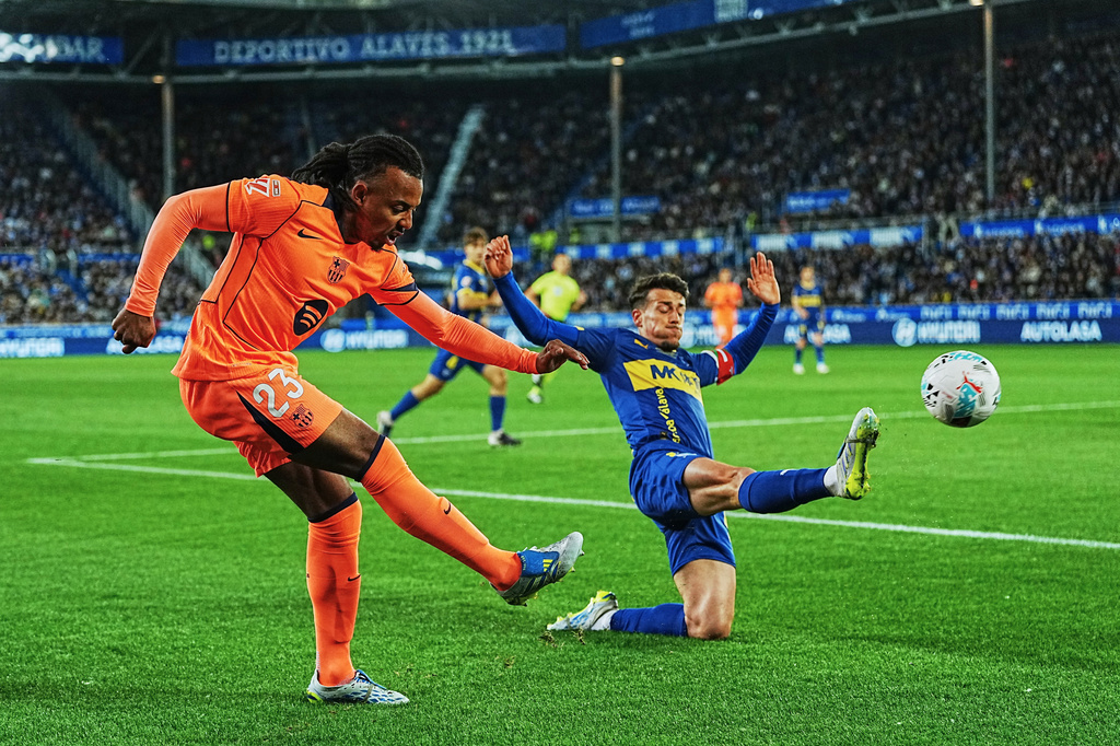 Barcelona's Jules Kounde, left, and Alaves' Antonio Blanco challenge for the ball during the Spanish La Liga soccer match between Alaves and Barcelona in Vitoria-Gasteiz, Spain, Wednesday, May 13, 2026. (AP Photo/Miguel Oses)