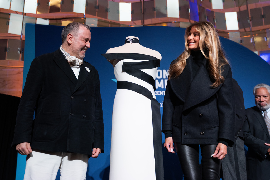 First lady Melania Trump and designer Hervé Pierre pose for a picture with her 2025 inaugural ball gown at the Smithsonian National Museum of American History, Friday, Feb. 20, 2026, in Washington. (AP Photo/Allison Robbert)