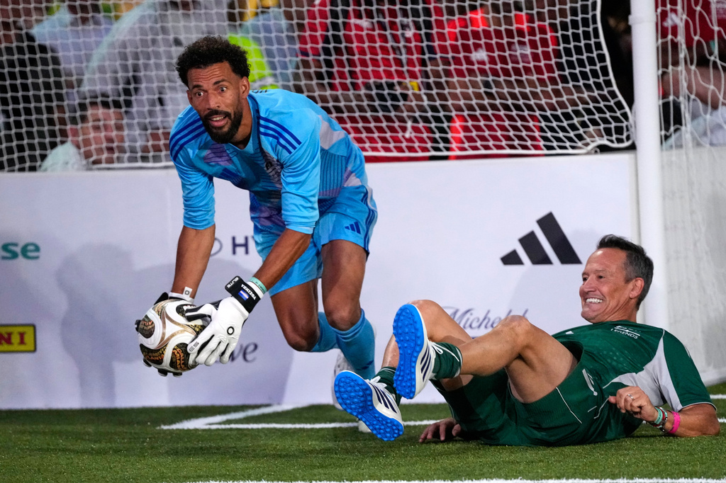 Cape Verde goalkeeper Vozinha gathers the ball ahead of former Mexican soccer player Luis Hernandez during a FIFA legends soccer match being played two days ahead of the World Cup final in New York, Friday, July 17, 2026. (AP Photo/Ashley Landis)