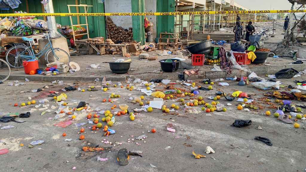 Police officers are seen at the scene of a bomb blast at a market in Maiduguri, Nigeria, Tuesday, March 17, 2026. (AP Photo/Jossy Ola )