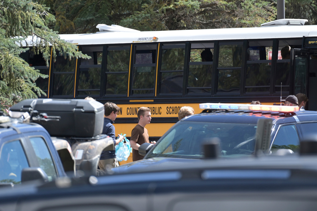 Students board a bus amid heavy police presence at the Evergreen Library after a shooting at Evergreen High School in Evergreen, Colo., on Wednesday, Sept. 10, 2025. (Hyoung Chang/The Denver Post via AP)