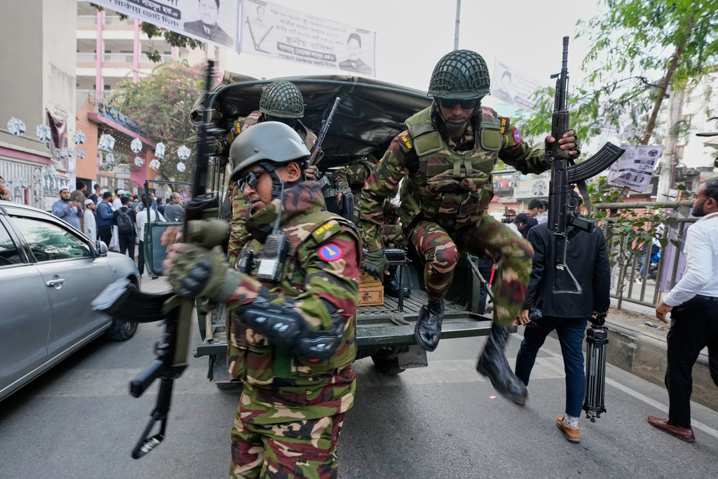 Army personnel jump from a vehicle outside a polling station during national parliamentary election in Dhaka, Bangladesh, Thursday, Feb. 12, 2026. (AP Photo/Anupam Nath)