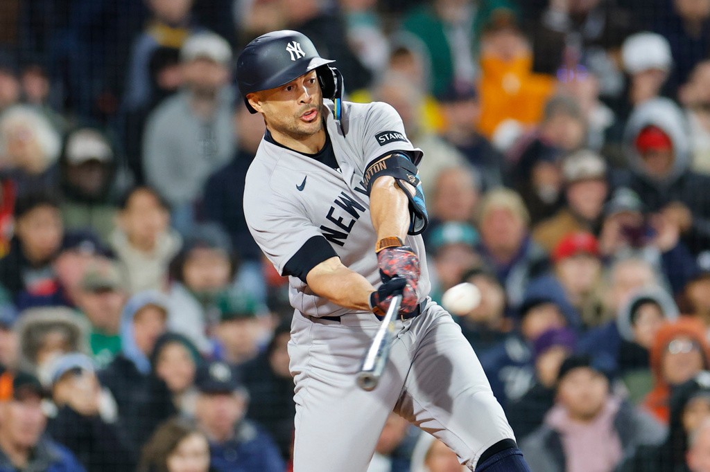 New York Yankees' Giancarlo Stanton hits a two-run double during the sixth inning of a baseball game against the Boston Red Sox, on Tuesday, April 21, 2026, in Boston. (AP Photo/CJ Gunther)