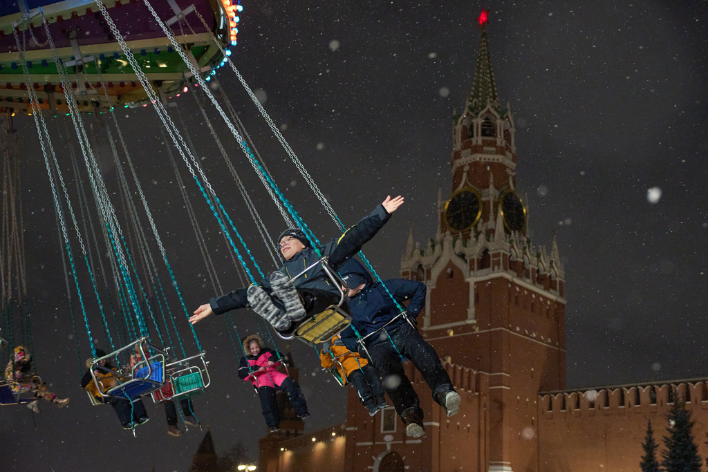 Children ride a carousel at the Christmas fair decorated for Christmas and the New Year festivities in Red Square in Moscow, Thursday, Dec. 25, 2025, with the Spasskaya Tower in the background. (AP Photo/Alexander Zemlianichenko)