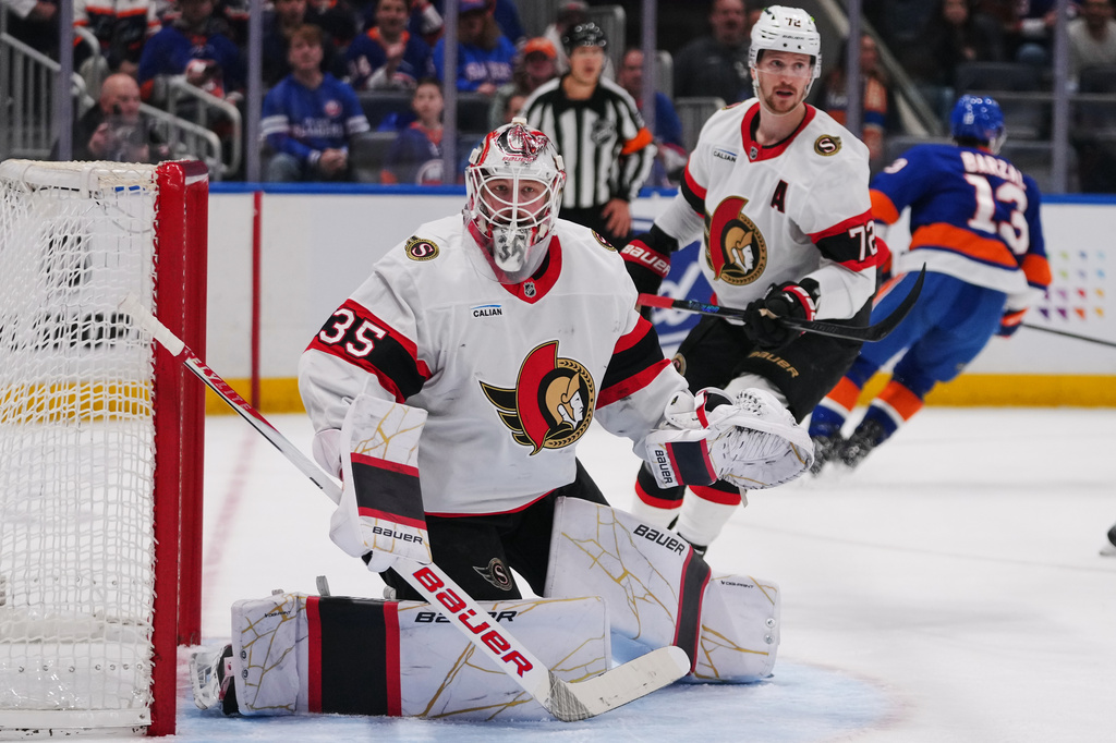 Ottawa Senators goaltender Linus Ullmark (35) and Thomas Chabot (72) protects the net during the second period of an NHL hockey game against the New York Islanders Saturday, April 11, 2026, in Elmont, N.Y. (AP Photo/Frank Franklin II)