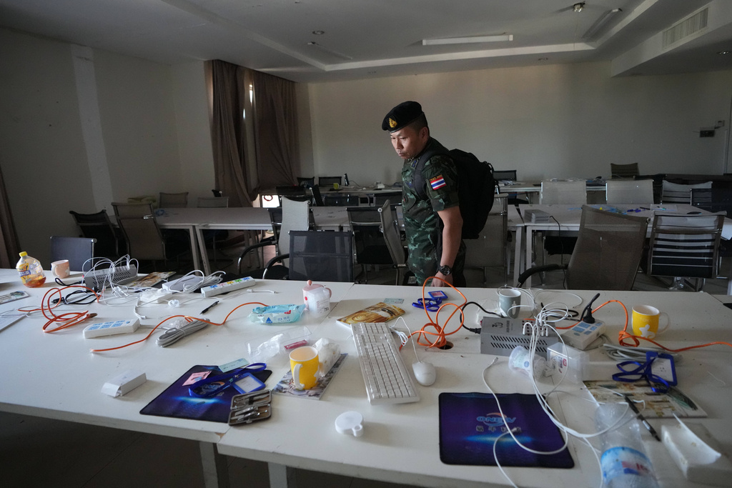 A Thai solider inspects a work station inside a scam center in O'Smach, Cambodia, Monday, Feb. 2, 2026, (AP Photo/Sakchai Lalit)