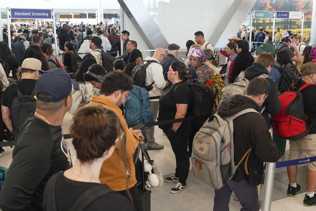 Airline passengers wait in long lines to get through the TSA security screening at George Bush Intercontinental Airport in Houston on Wednesday, March 18, 2026. (AP Photo/Lekan Oyekanmi)