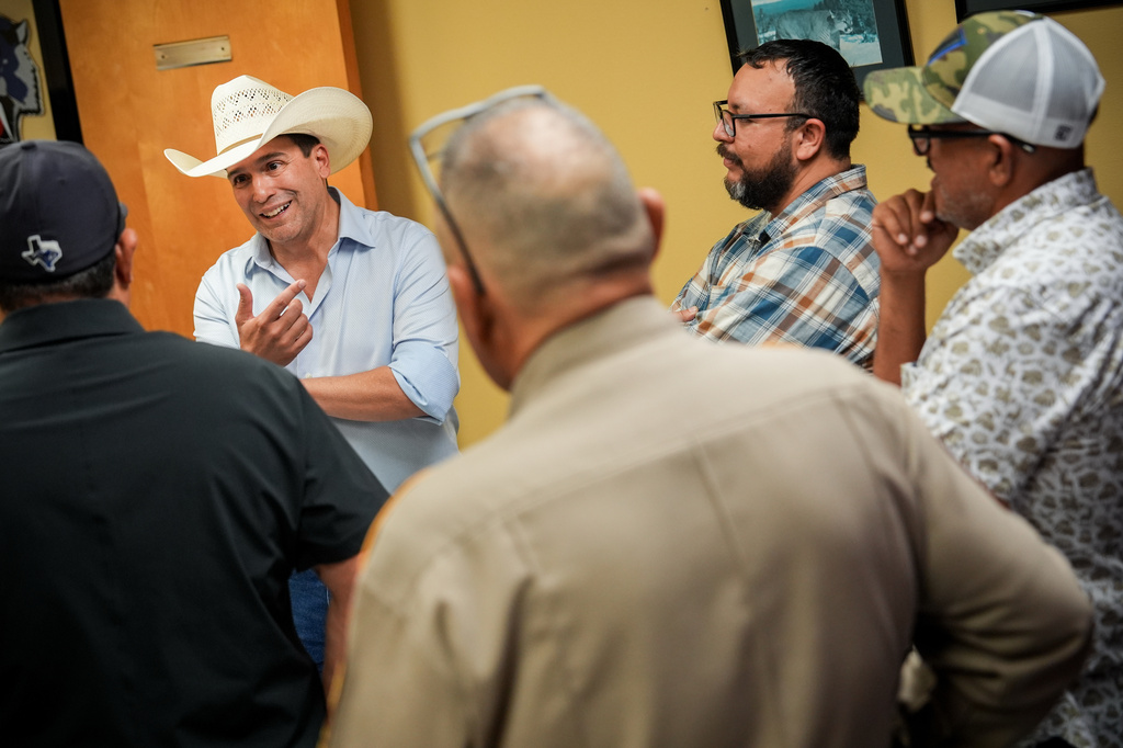 Democratic candidate for congress Bobby Pulido, second from left, attends a football game between Edcouch-Elsa High School and Robert Vela High School, Thursday, Sept. 17, 2026, at Richard R. Flores Stadium in Edinburg, Texas. (AP Photo/Julia Demaree Nikhinson)