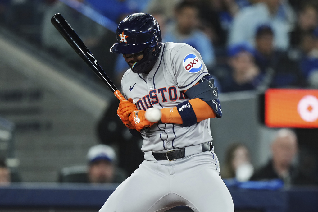 Houston Astros' Carlos Correa (1) is hit by a pitch against the Toronto Blue Jays during seventh inning MLB baseball action in Toronto on Tuesday, Sept. 9, 2025. (Nathan Denette/The Canadian Press via AP)