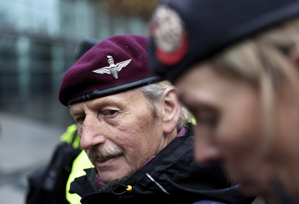 Supporters of soldier F stand outside of Belfast Crown Court, where the trial of a former paratrooper accused of the murder of two men on Bloody Sunday is taking place, in Belfast, Northern Ireland, Monday, Sept. 15, 2025. (AP Photo/Peter Morrison)
