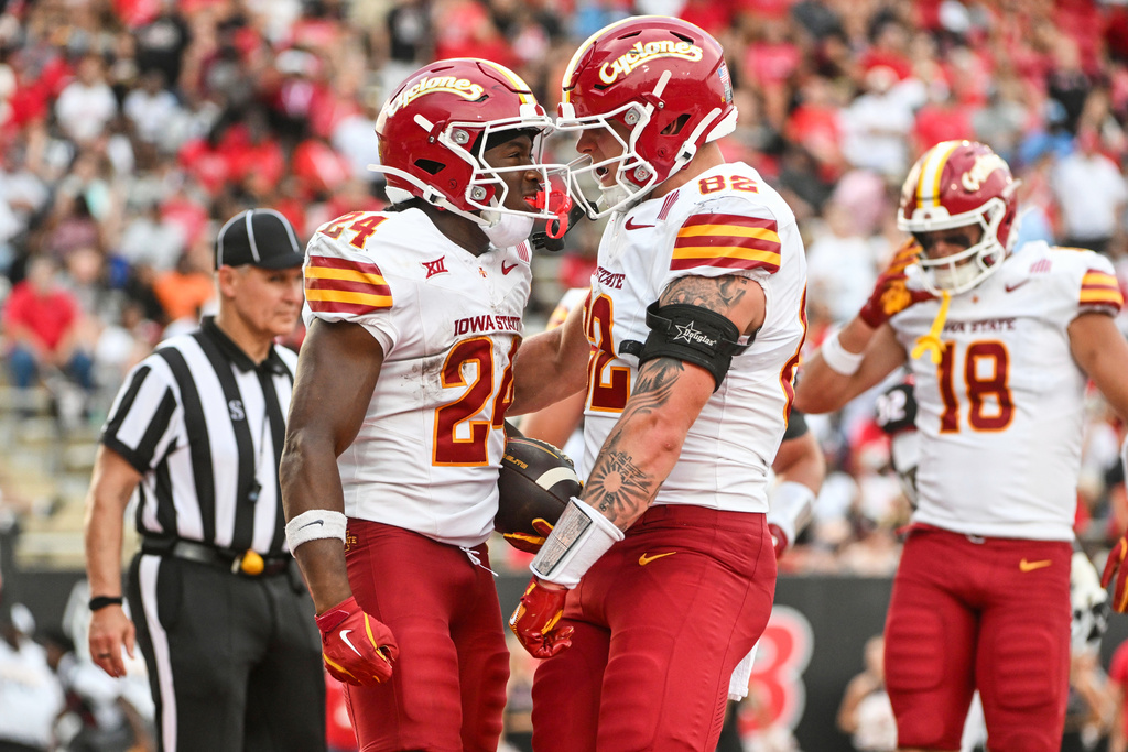 Iowa State running back Abu Sama III (24) celebrates with teammate Tyler Moore (82) after scoring a touchdown against Arkansas State during an NCAA college football game Saturday, Sept. 13, 2025, in Jonesboro, Ark. (AP Photo/Michael Woods)
