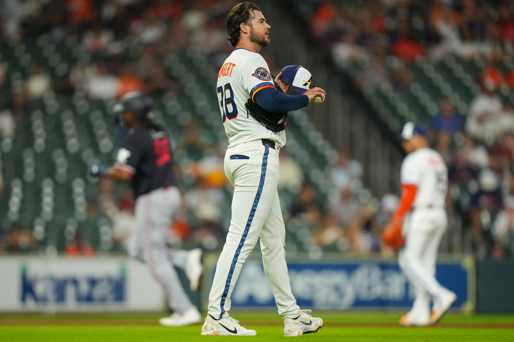 Houston Astros starting pitcher Peter Lambert, foreground, waits on the mound as Minnesota Twins designated hitter Josh Bell, back left, rounds the bases after hitting a home run during the sixth inning of a baseball game in Houston, Monday, June 29, 2026. (AP Photo/Jon Shapley)