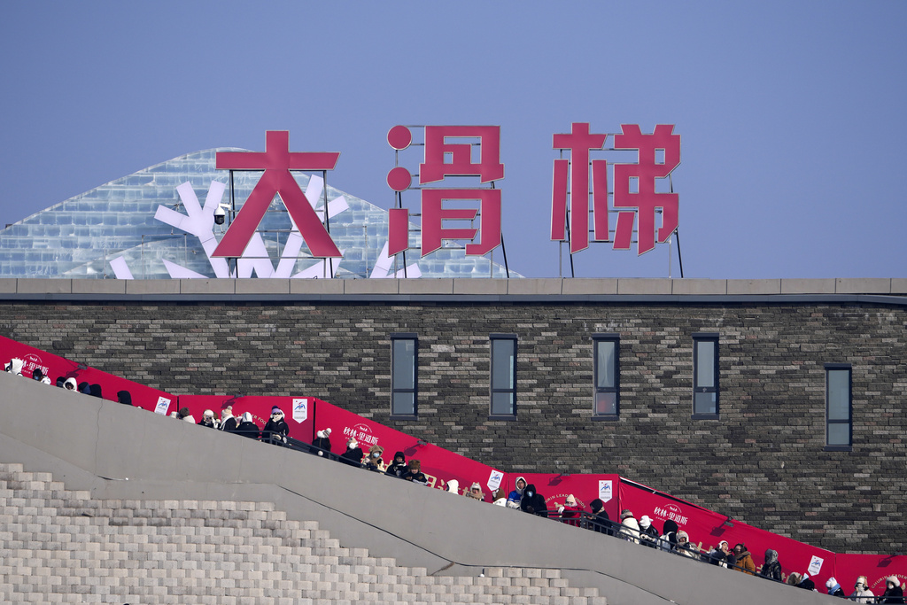 Visitors line-up to ride a giant ice block slides at the Harbin Ice and Snow World in Harbin, China's Heilongjiang province on Monday, Jan. 6, 2025. (AP Photo/Andy Wong)