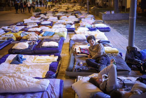 Students rest on a street while taking a break on their march to Novi Sad for a rally on Nov. 1 marking the first anniversary of a train station disaster that killed 16 people, in Indjija, Serbia, Friday, Oct. 31, 2025. (AP Photo/Armin Durgut) Students rest on a street while taking a break on their march to Novi Sad for a rally on Nov. 1 marking the first anniversary of a train station disaster that killed 16 people, in Indjija, Serbia, Friday, Oct. 31, 2025. (AP Photo/Armin Durgut)