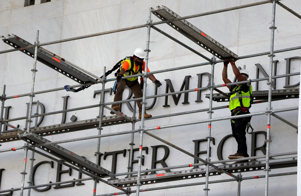 Workers construct scaffolding at the sign for the John F. Kennedy Center for the Performing Arts, Friday, June 12, 2026, in Washington. (AP Photo/Rahmat Gul)