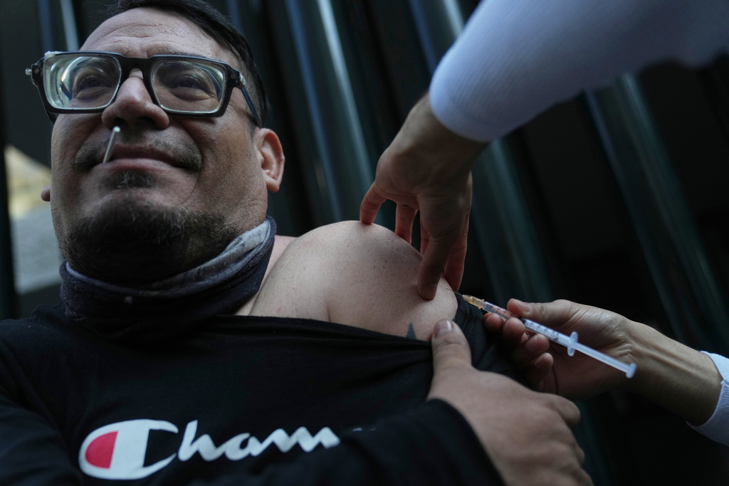 A health worker administers a dose of the measles vaccine outside a public hospital in Mexico City, Wednesday, Feb. 4, 2026. (AP Photo/Marco Ugarte)
