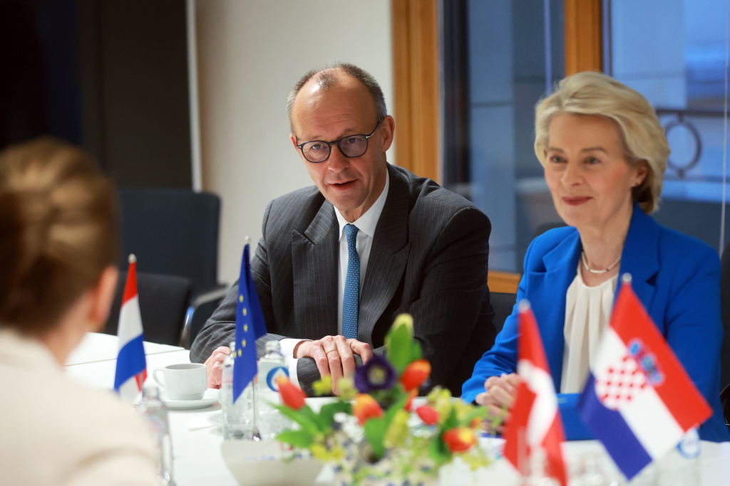 European Commission President Ursula von der Leyen, right, and Germany's Chancellor Friedrich Merz, left, attend a round table meeting on migration at the EU Summit in Brussels, Thursday, Dec. 18, 2025. (AP Photo/Olivier Hoslet, Pool Photo via AP)